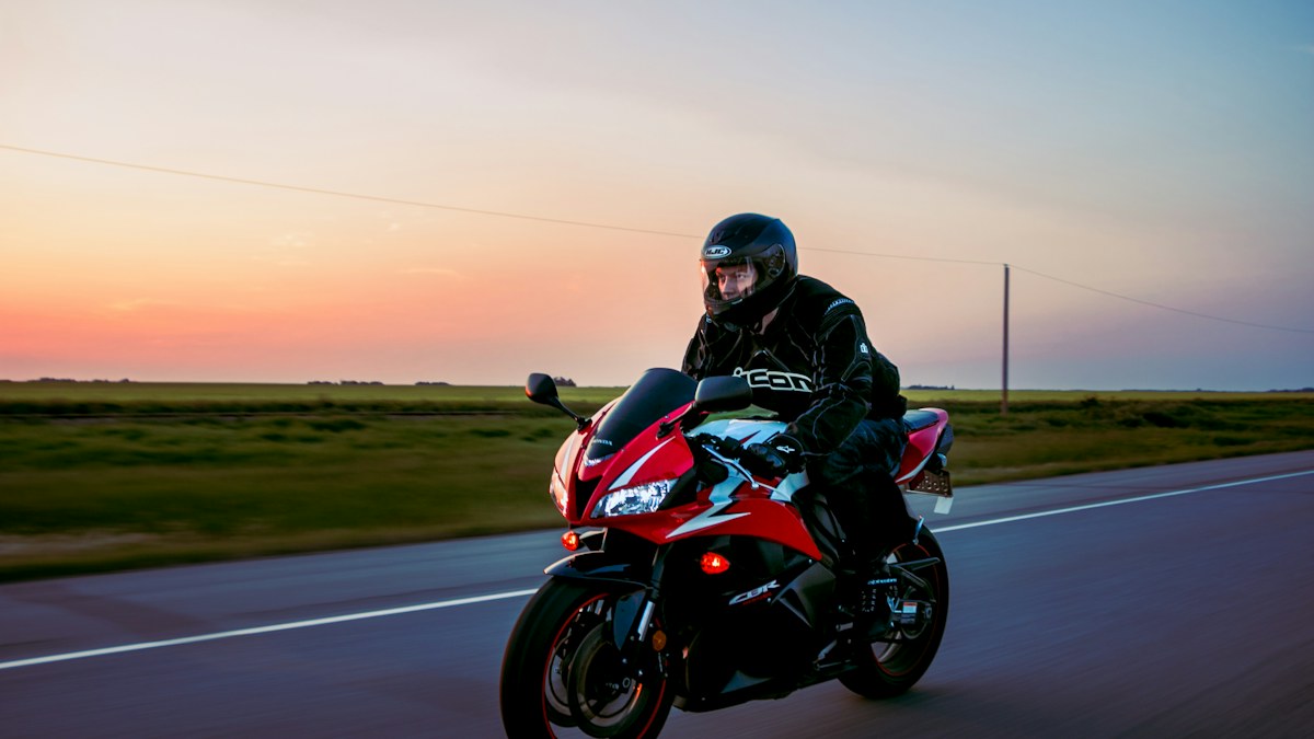 Sport motorcycle on an open road at sunset