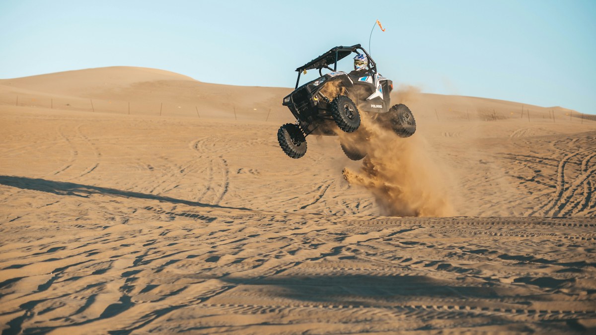 UTV side-by-side jumping a sand dune