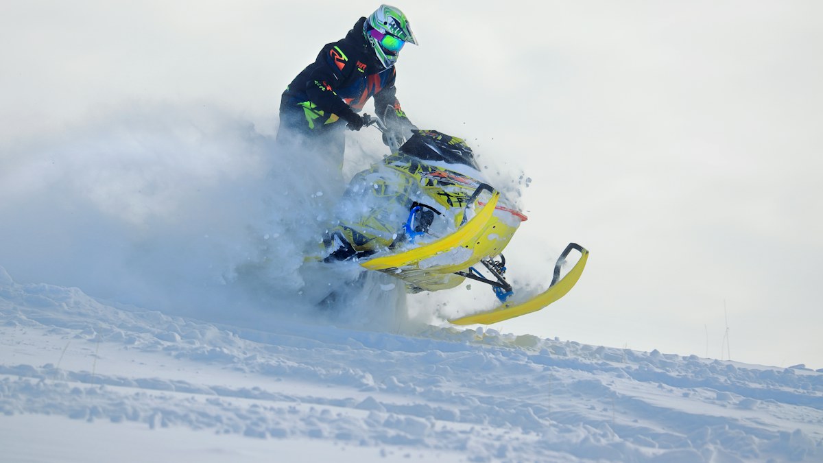 Snowmobile carving through deep powder